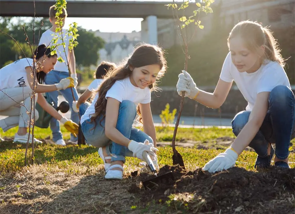 Photo, children planting trees, EnerWisely, partner with us, let's make climate action everyone's superpower
